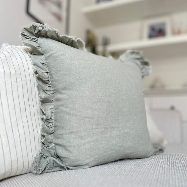 Ruffled edge sage green linen square cushion.