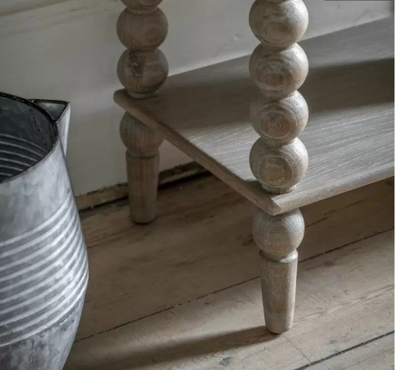 Close up of the oak Bobbin legs, with a lime wash effect and wooden round bobbles one on top of the other to create a leg.