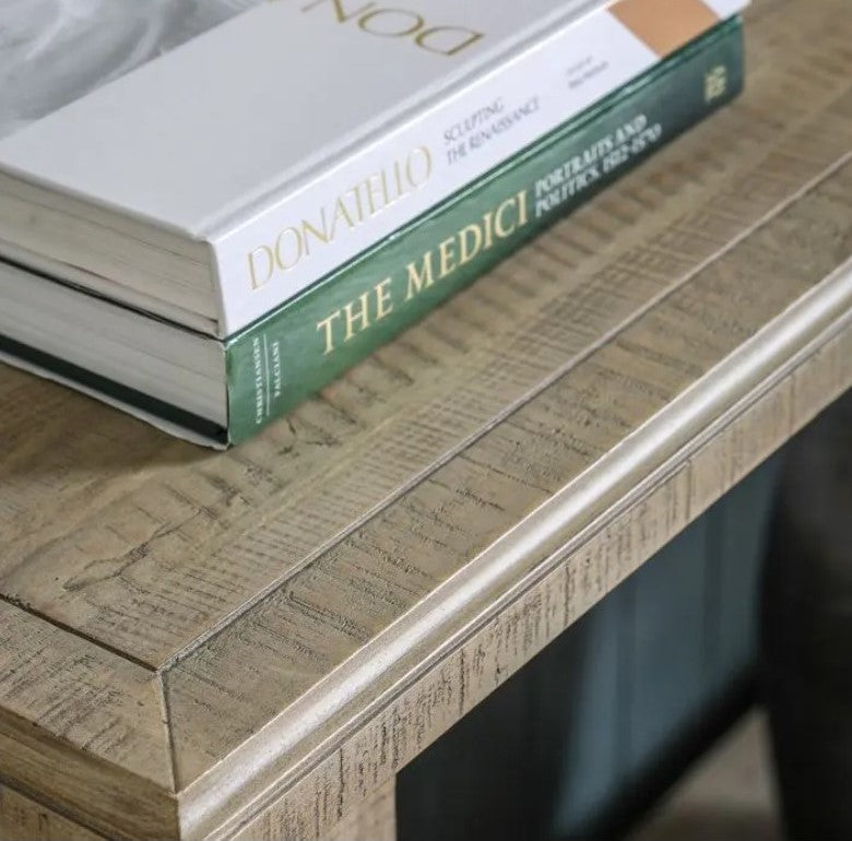 birds eye close up of the wooden top of the console table showing a carved edge all the way around the top of the table and displaying the natural wood grain of the pine woo.