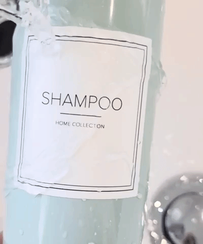 Ivory square label saying shampoo in capital stuck on a sage green pump bottle ran under water to show waterproof quality